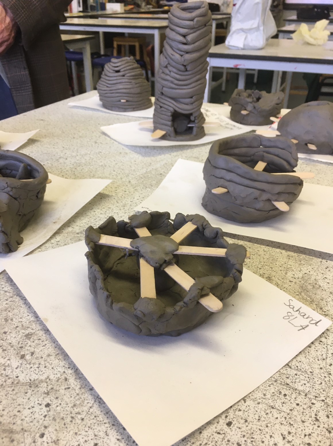 Photo of students making clay pots